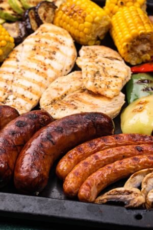 Grilled sausages, meat, and vegetables.